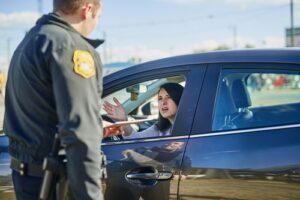 Woman Receiving Traffic Violation From Officer